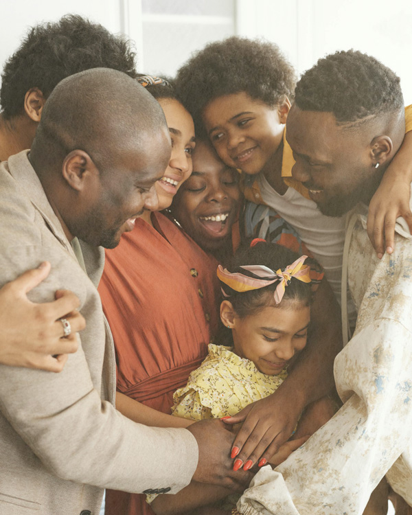 Family embracing each other during a supportive family therapy session.