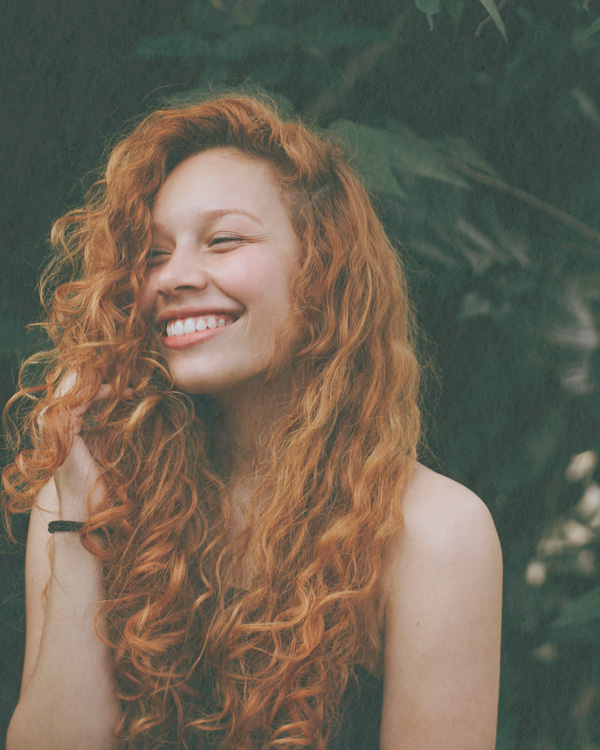Young woman smiling during an attachment-style interview therapy session